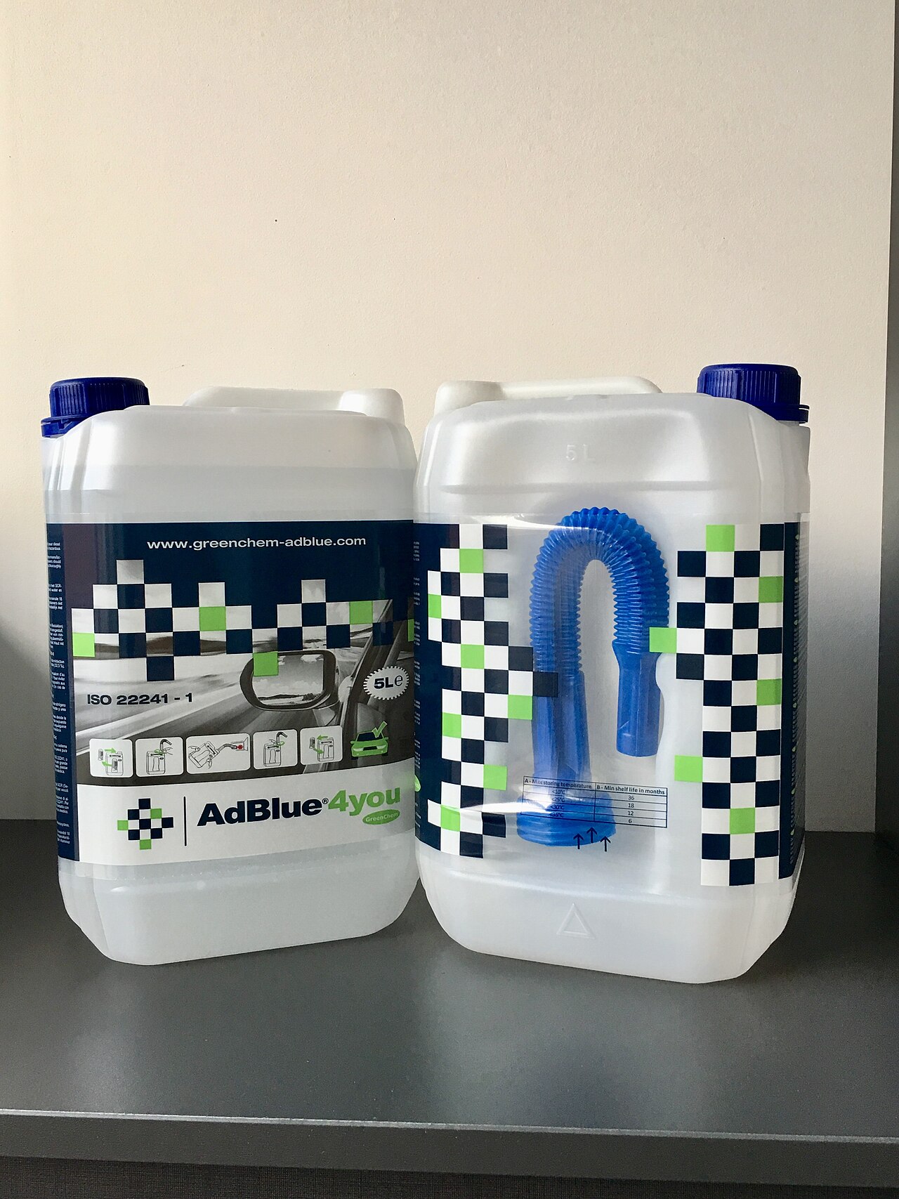 Five-liter diesel exhaust fluid containers with dedicated refill spout